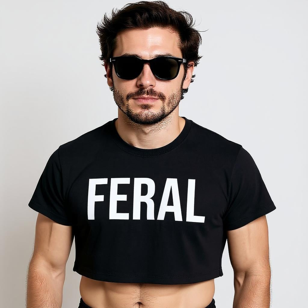 Man in black crop top with bold 'FERAL' text, edgy streetwear style for LGBTQ+ fashion and nightlife culture