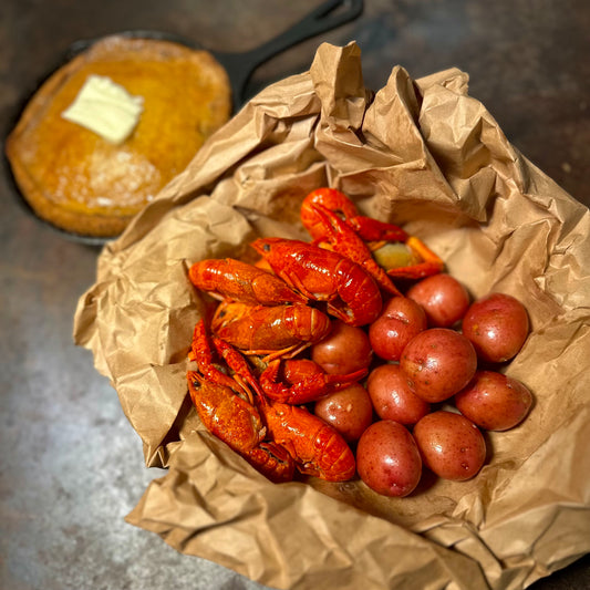Pinch Me Daddy dish with Cajun crawfish and buttery baby potatoes, served hot at a queer-owned seafood spot in West Hollywood.