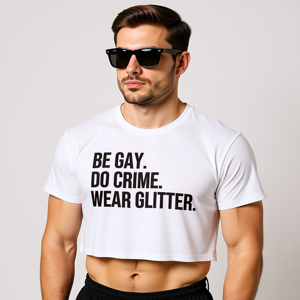 Man wearing a white t-shirt with text 'BE GAY. DO CRIME. WEAR GLITTER.' on a plain background