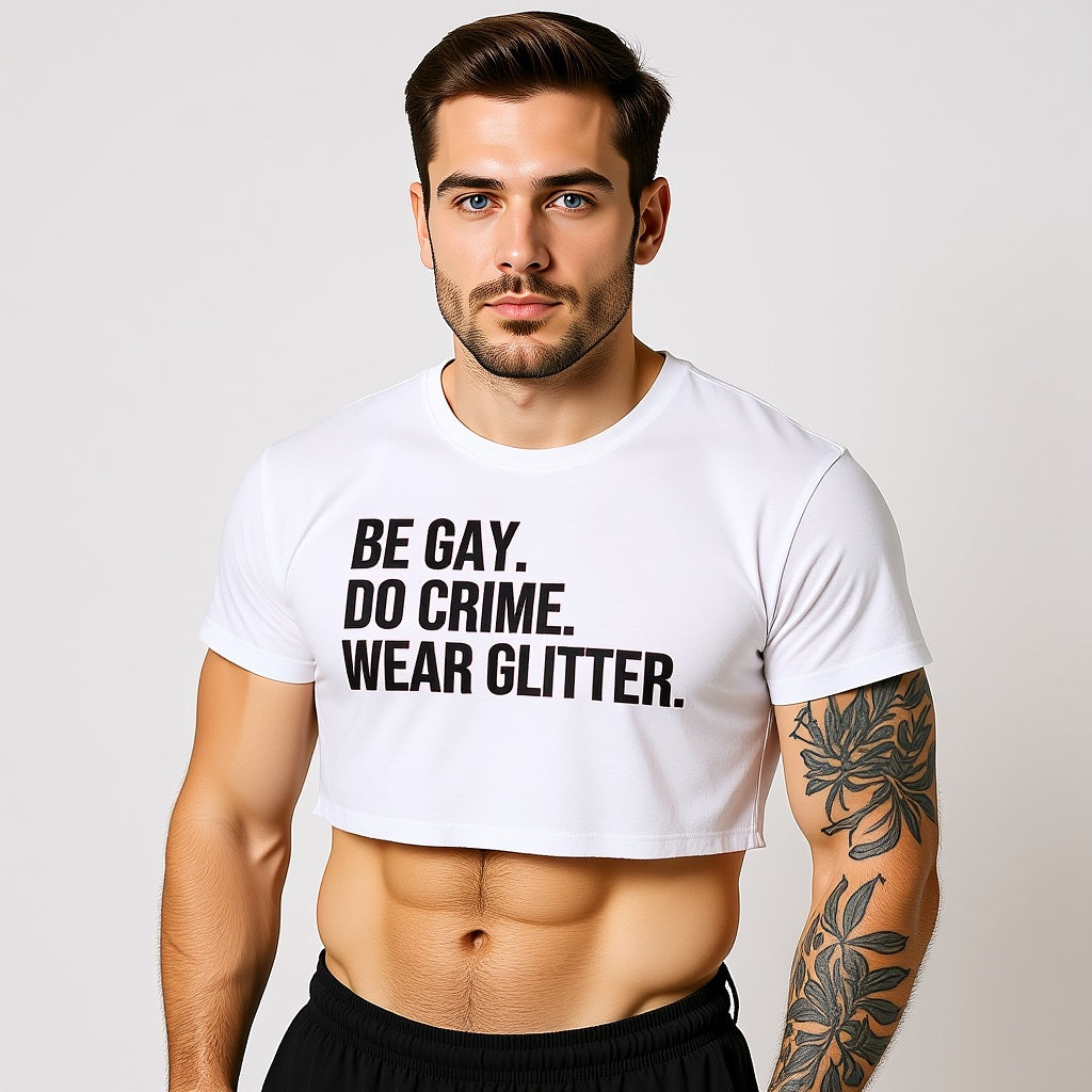 Man wearing a white t-shirt with text 'BE GAY. DO CRIME. WEAR GLITTER.' on a plain background