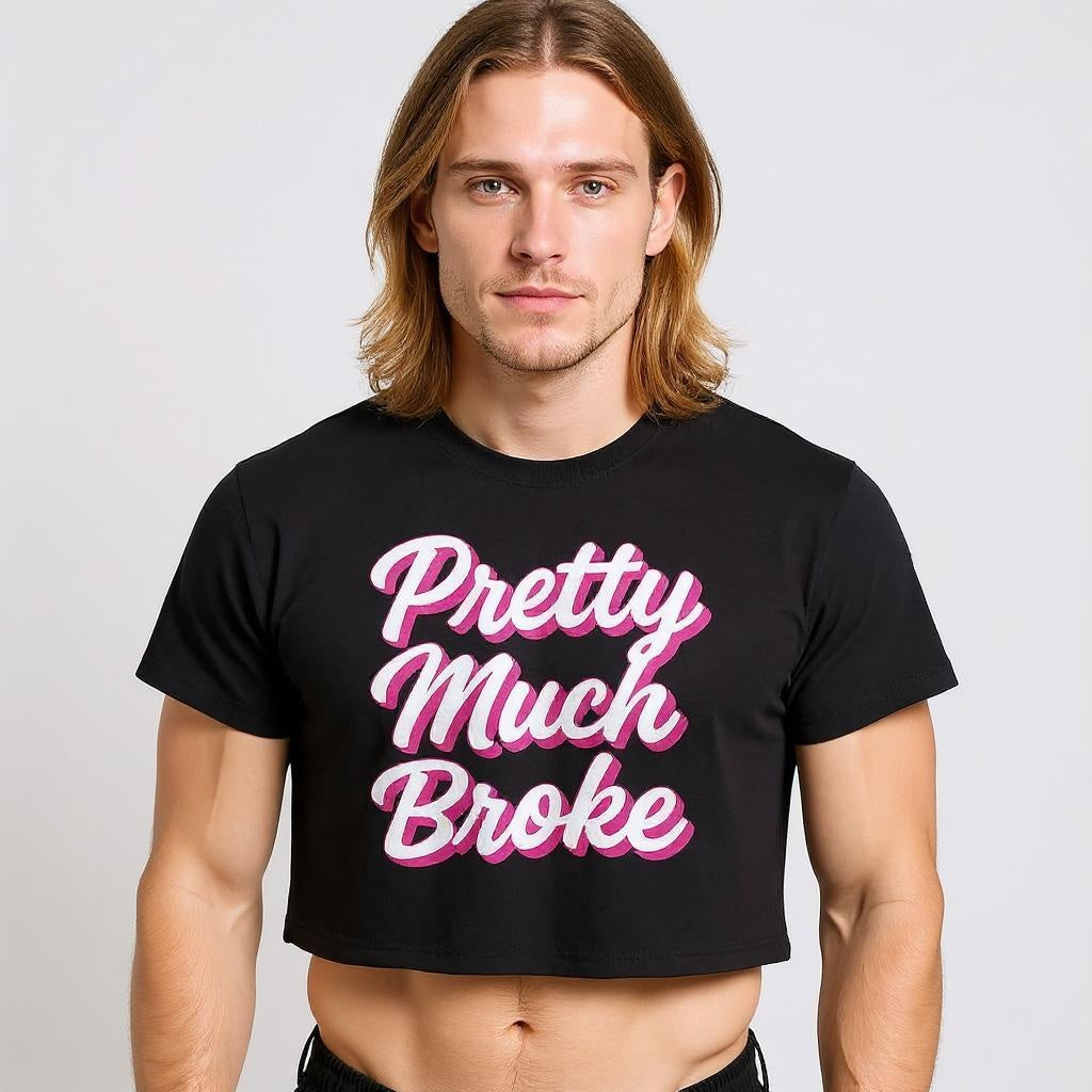 Model wearing a black crop top with bold pink and white script that reads “Pretty Much Broke,” representing queer humor, gender-inclusive streetwear, and TikTok-inspired LGBTQ+ fashion.