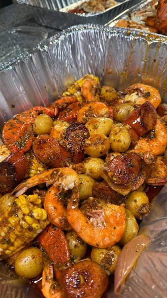 Seafood boil with shrimp, sausage, corn and potatoes in Cajun garlic butter at Boil Baby Boil in West Hollywood
