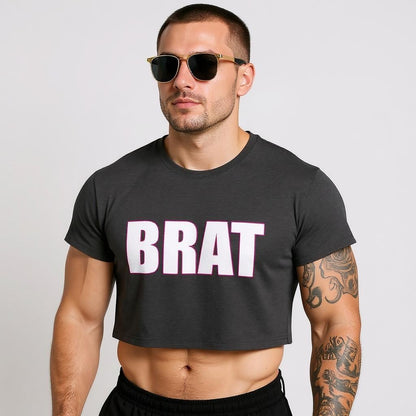 Man wearing a black t-shirt with 'BRAT' text and sunglasses on a light gray background