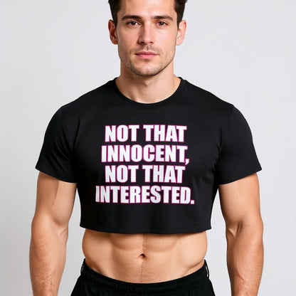A cute boy wearing a black Britney t-shirt with pink text on a plain background that says, "Not that innocent, not that interested."