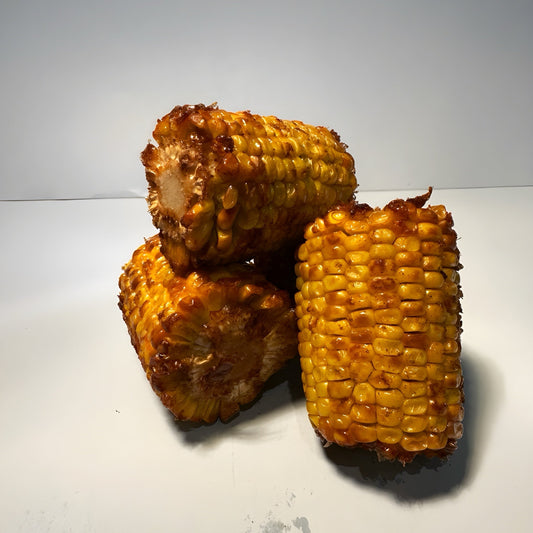 Sweet Cajun baby corn covered in garlic butter and Cajun seasoning, served hot at a West Hollywood LGBTQ+-owned restaurant.