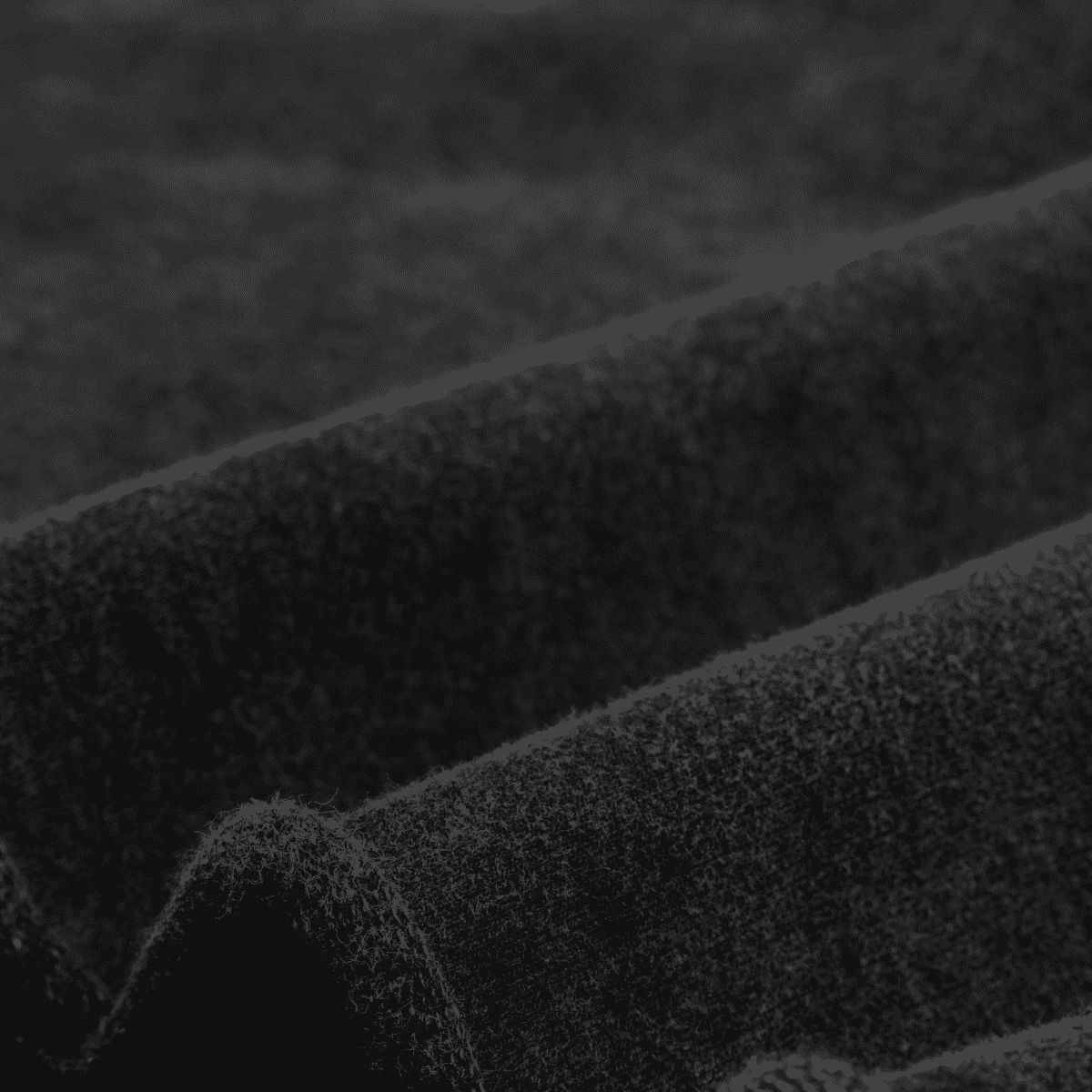 Close-up of textured black fabric with a blurred background