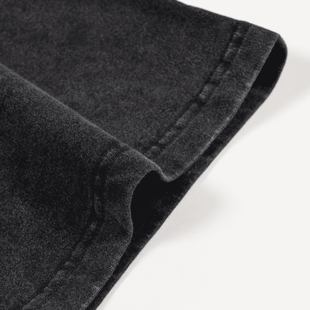 Close-up of black denim fabric on a white background