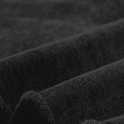 Close-up of textured black fabric with a blurred background