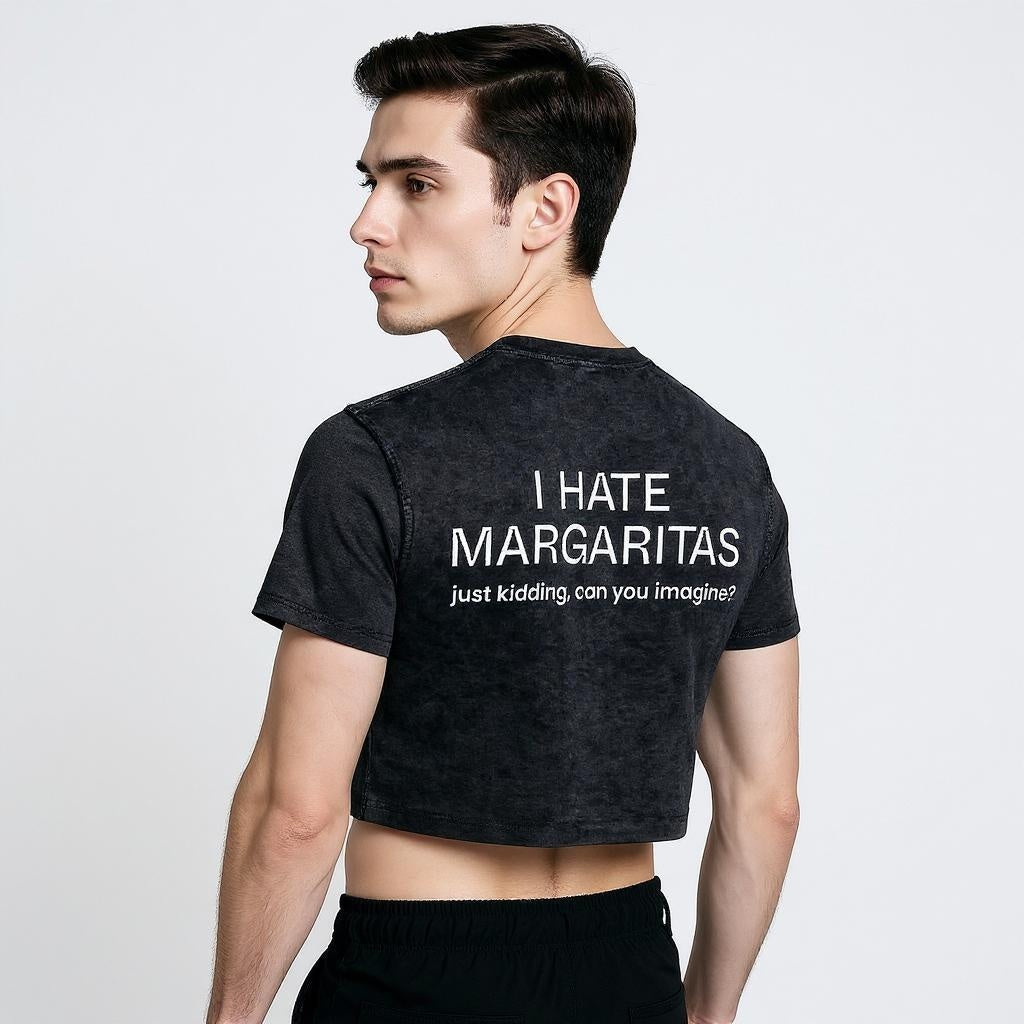Stylish man in a black crop top with white text reading 'I HATE MARGARITAS—just kidding, can you imagine?' — cheeky LGBTQ+ fashion with Gen Z humor.