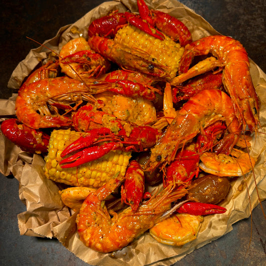 Lil’ Cajun Cutie seafood boil with shrimp, crawfish, sausage, and sides, made for one at a queer-friendly West Hollywood seafood spot.