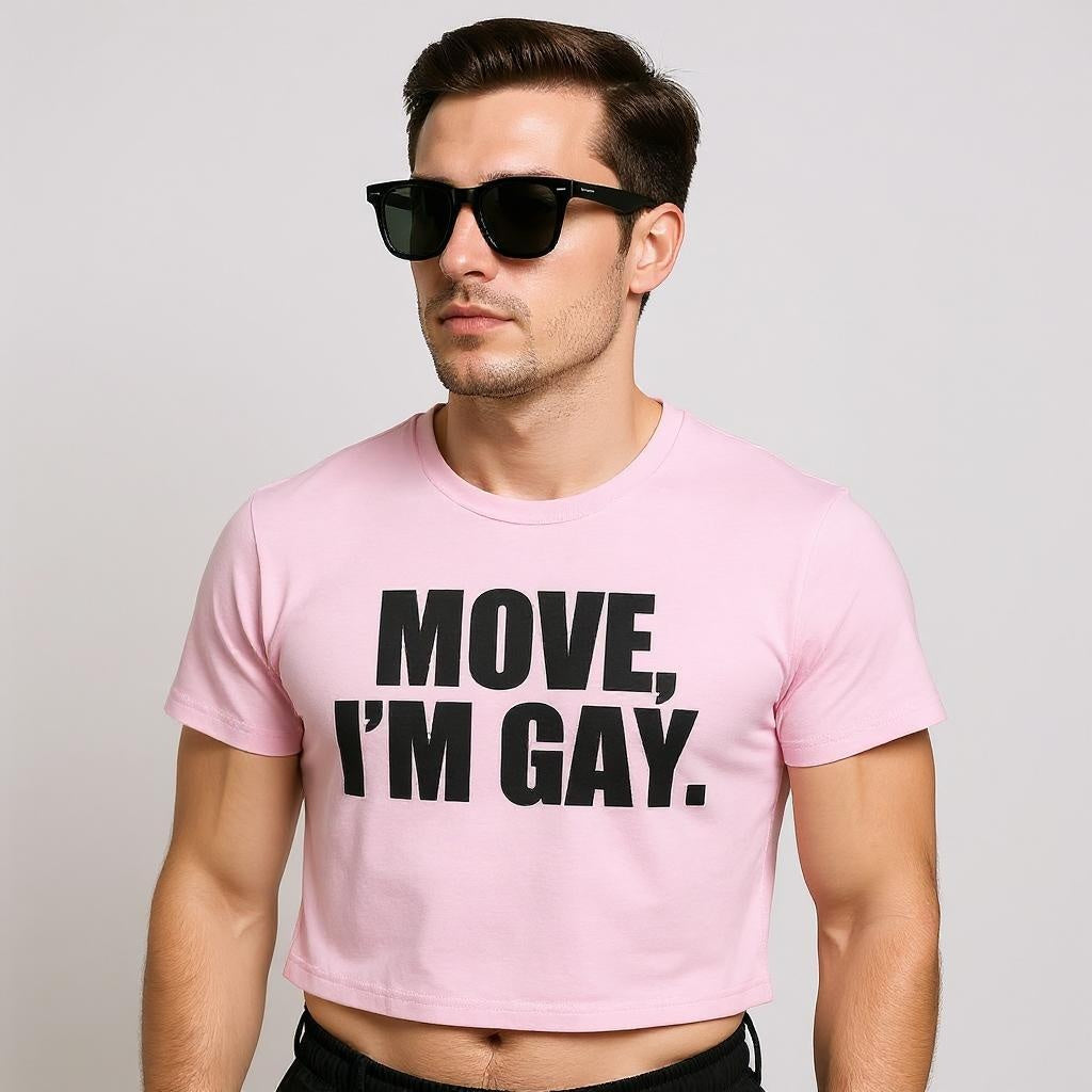 A confident model in a pink crop top with bold black text reading “MOVE, I’M GAY,” serving queer streetwear energy and body-positive LGBTQ+ fashion.