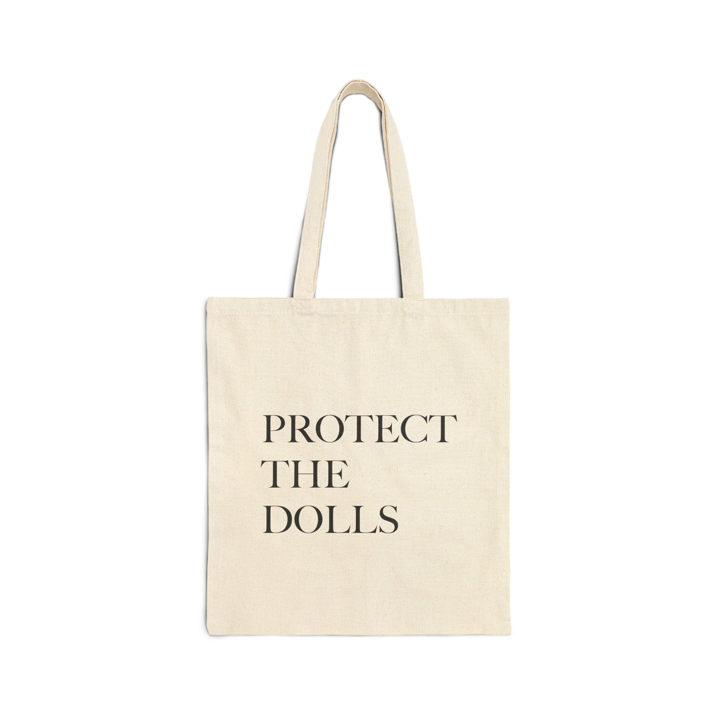 Beige tote bag with 'PROTECT THE DOLLS' text on a white background