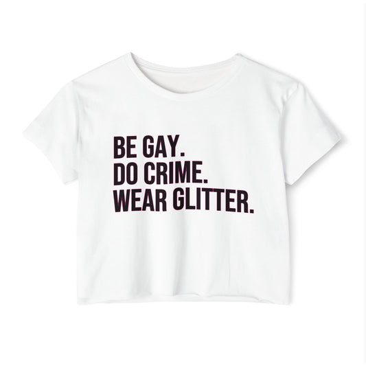White t-shirt with black text 'BE GAY. DO CRIME. WEAR GLITTER.' on a white background