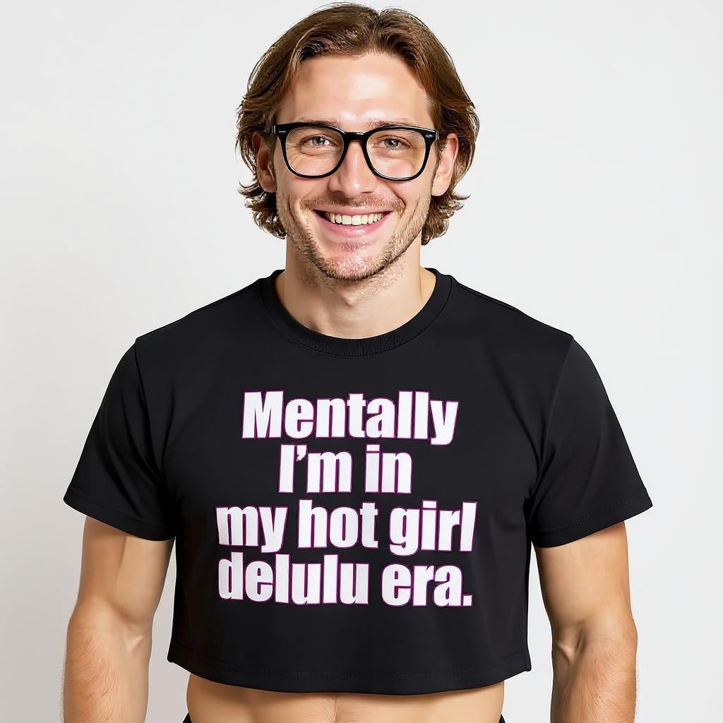 Man wearing a black t-shirt with humorous text design on a plain background