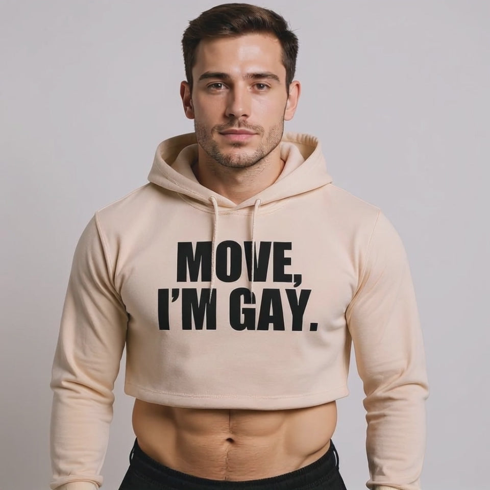 The model is wearing a beige crop hoodie with bold black text reading “MOVE, I’M GAY,” showcasing queer streetwear, gender-inclusive fashion, and unapologetic LGBTQ+ pride style.
