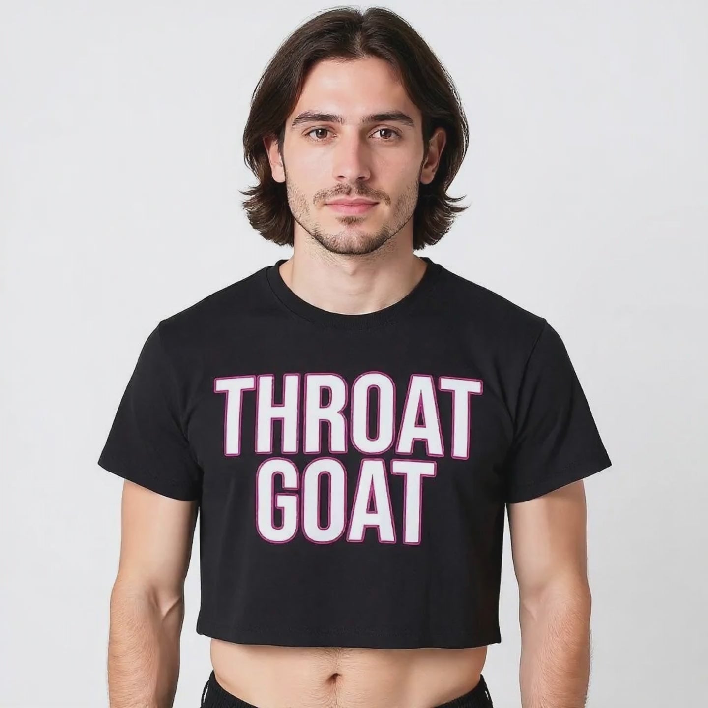 A male model wearing a crop top that is black with the words "Throat Goat" in white lettering and a pink outline on the front.