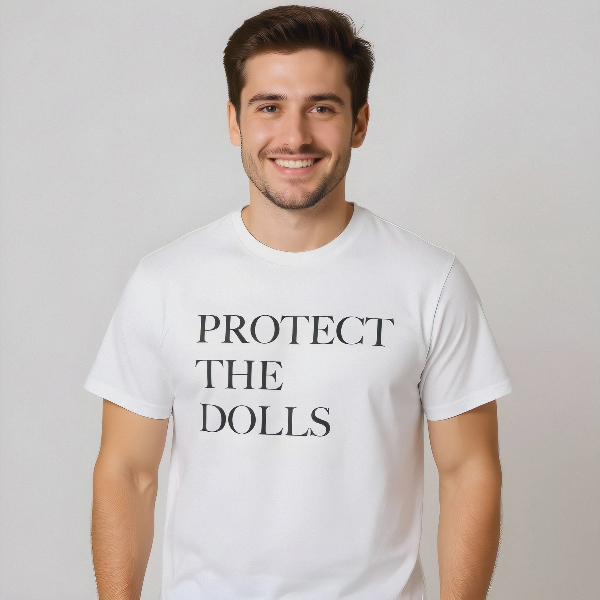 Person wearing a black “Protect the Dolls” T-shirt—bold pro-drag, pro-trans message.