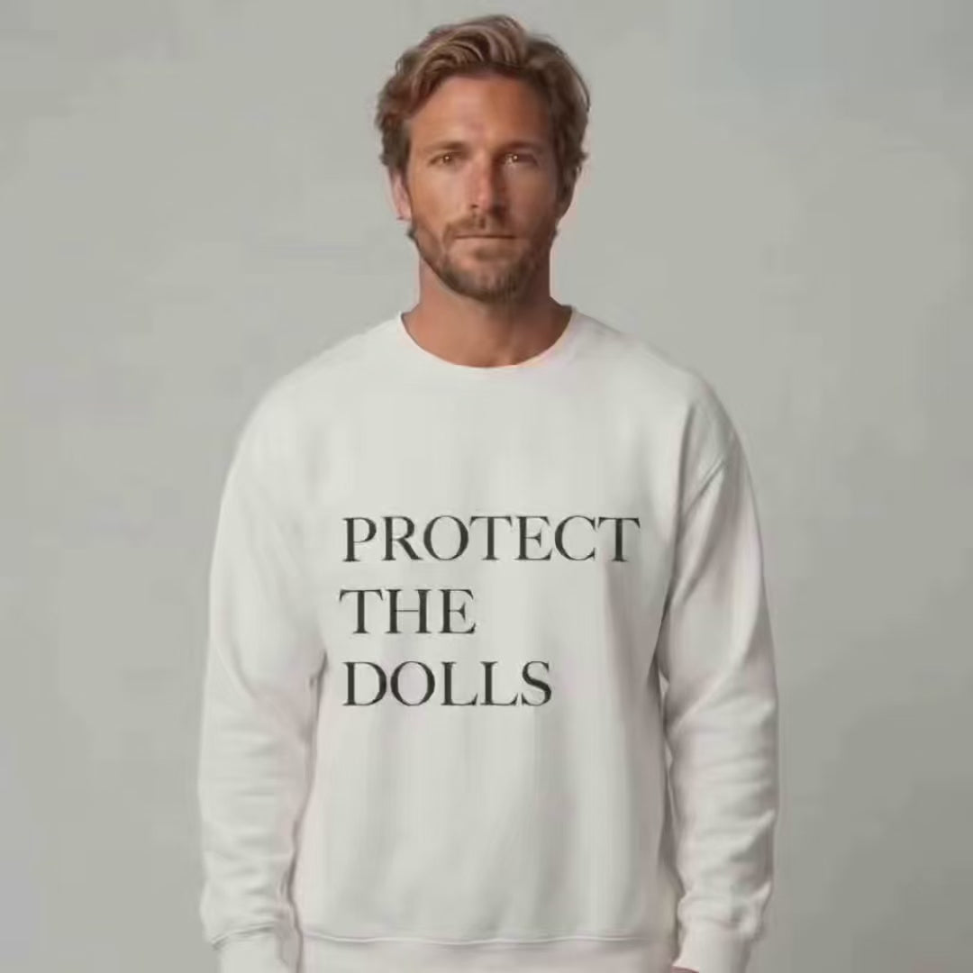 Protect the Dolls crewneck donation: a man wearing the trending crewneck with the words "Protect The Dolls" in black writing on the front of a white crewneck sweatshirt.