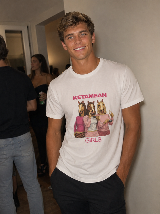 Man wearing a white t-shirt with graphic design "Ketamean Girls" and text, standing indoors.