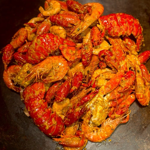 Main Character seafood boil with shrimp, crab legs, lobster tails, and sides, served at a bold LGBTQ+-friendly spot in West Hollywood.